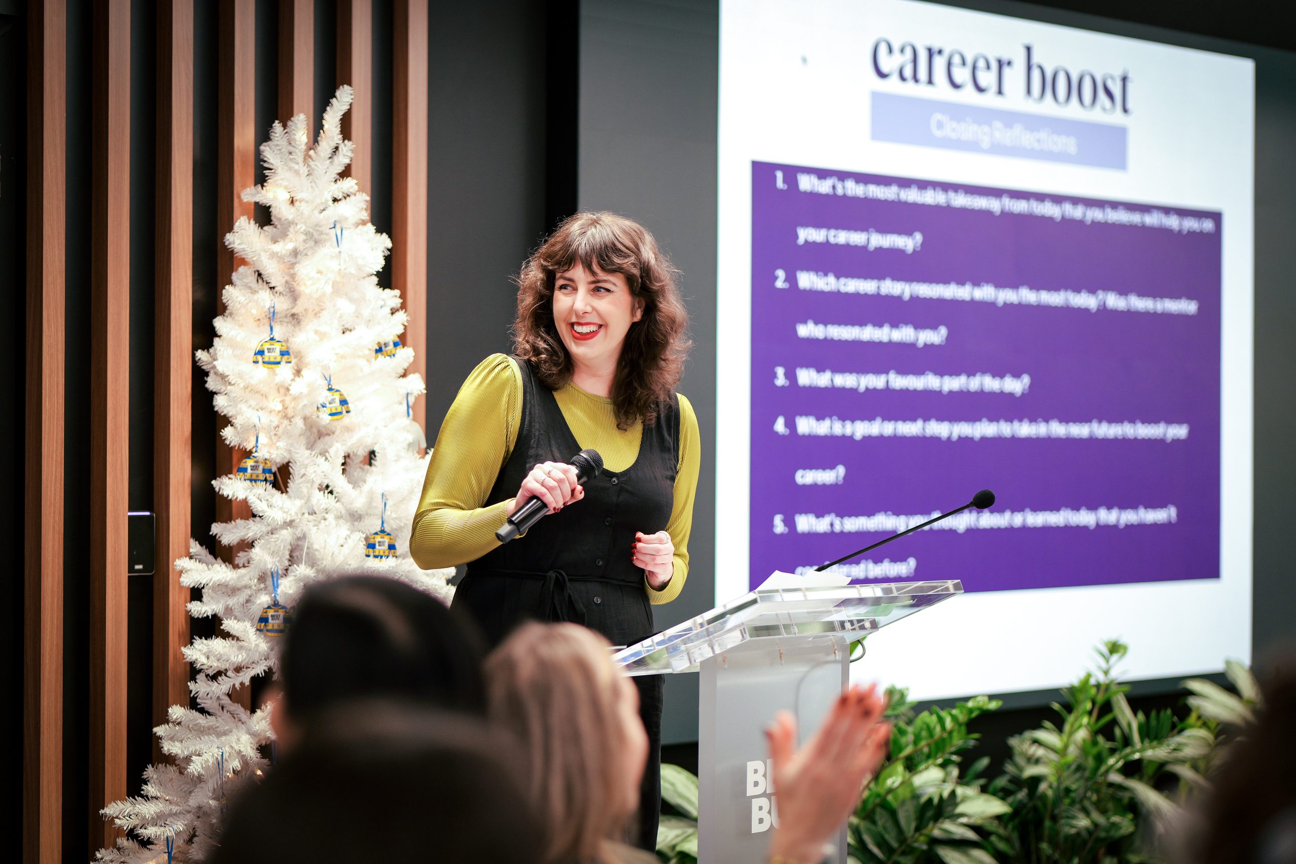 woman speaking and leading an event